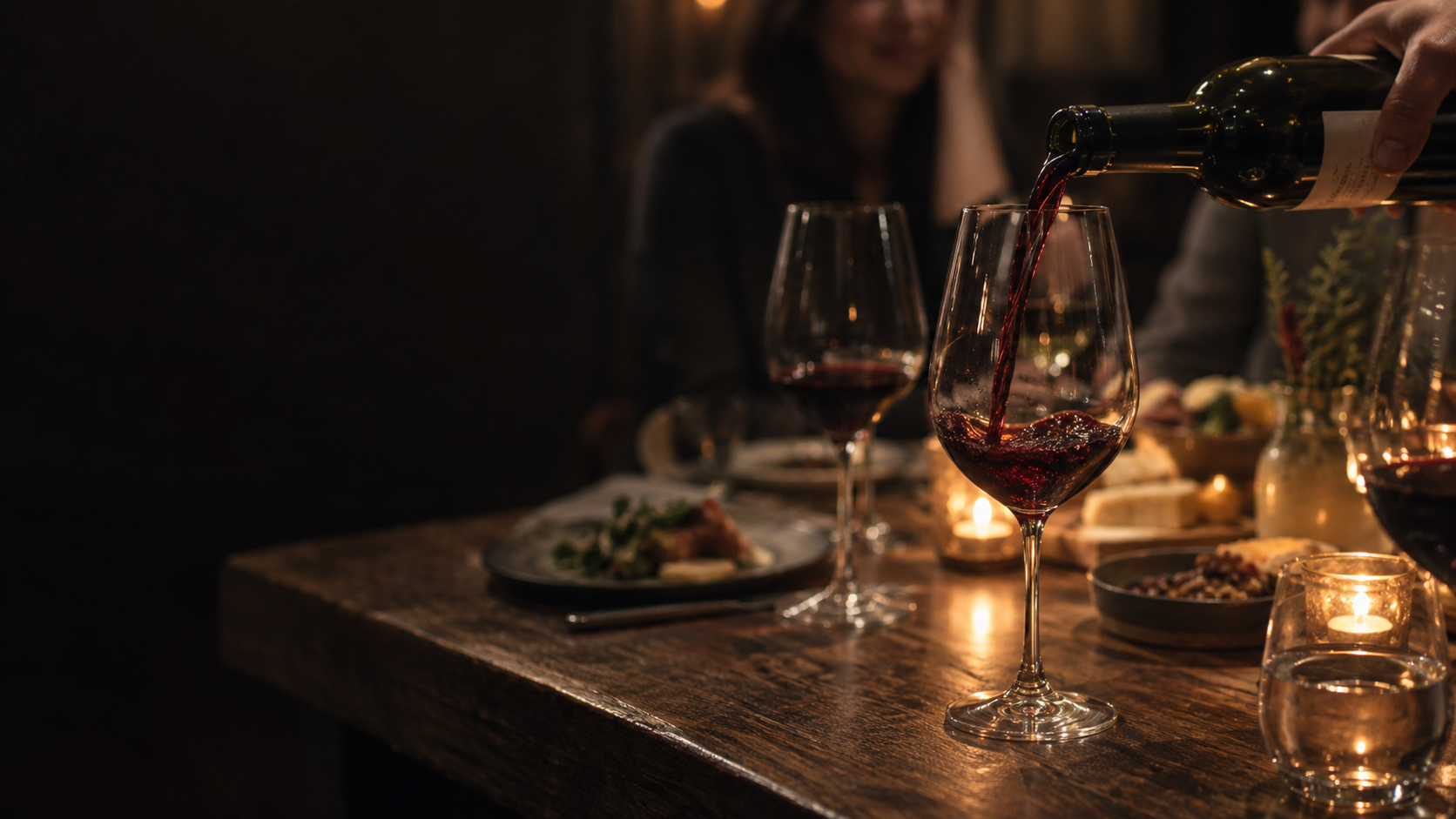 Illustrative candlelit wine and dinner scene
